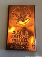 Front view of the copper bar showing the 'Legalize It' logo, cannabis leaf design, and text with year, weight, purity, and country.