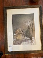 Framed print showing full artwork and frame with woods and snow scene with moon at night.