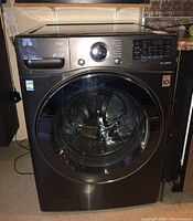 Front view of LG ThinQ all-in-one washer dryer installed under counter