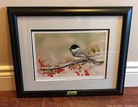 Framed print titled "Cardinal Pair" featuring a bird on a branch with red berries, showing the overall condition and framing details.