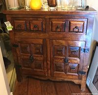Front view of cabinet closed showing two drawers and raised panel doors