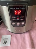 Close-up of the digital control panel on the Breville Fast Slow Cooker showing illuminated LED display and buttons.