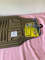 Top side view of a Goodyear rubber car mat with packaging label showing model number 6302.