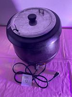 Closed electric soup warmer showing exterior, lid with handle, control knob and power cord.
