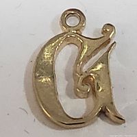Close-up front view of the 10K yellow gold letter G pendant showing ornate design and loop.