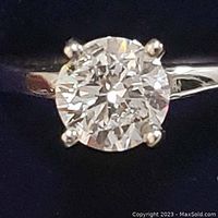 Front view of solitaire ring showing round diamond and four-prong setting