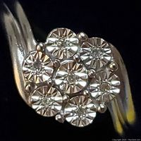 Front view of ring head showing cluster of seven round diamonds