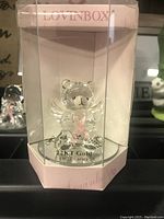 Front view of the crystal teddy bear figurine inside clear packaging with Lovingbox branding and indication of 22KT gold detail.