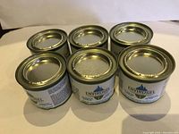 Six tins of Envirogel heating fuel gel arranged in two rows of three, showing product labels and metal lids.