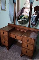 Full front view of antique dresser with three oval mirrors and six drawers showing general condition and design