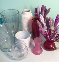 All vases grouped showing variety of materials and shapes with lavender sprigs included