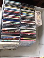Photo showing stacks of around 50 CDs including artists Neil Diamond, Elvis, Johnny Cash and various genres including classical and meditation.