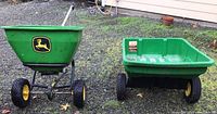 Side-by-side view of both John Deere tow-behind attachments on gravel surface