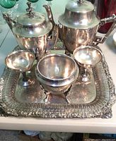 Full set on tray showing teapot, coffee pot, sugar bowl, and two champagne glasses on silver serving tray.