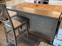 Full frontal view of island with one counter-height chair positioned at bar