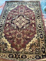 Full view of the India House area rug showing the mauve central medallion and detailed border design on a light background with floral motifs.