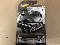 Photo of sealed Hot Wheels diecast car model on original card showing the 1964 Lincoln Continental from James Bond Goldfinger series.