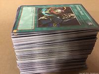 Side view showing the large stack of Yugioh cards, indicating quantity and thickness.