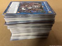 Stack of over 200 Yu-Gi-Oh! trading cards showing side view of card edges.