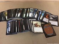 Large spread of Magic the Gathering cards laid out showing front faces and backs.