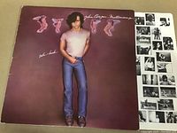 Photo of John Cougar Mellencamp LP "Uh-Huh" album cover with artist standing centered.