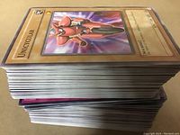 Stack of Yu-Gi-Oh! cards showing the top card 'Unicycular' and the edges of the card stack.