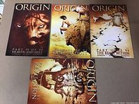 Four high-grade Marvel Origin Wolverine comic books with illustrated covers featuring characters and scenes from the storyline.