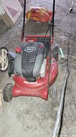 Front angled view of Craftsman EZ Walk lawnmower showing overall body, wheels and handle.