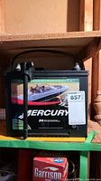 Front view of Mercury marine battery with label showing boat image and brand name.