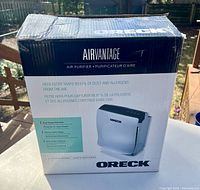 Box of Oreck AirVantage air purifier showing product image, HEPA filter info, and features.