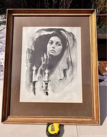 Full framed artwork featuring a woman with Shabbat candles, signed by artist Sandu Lieberman.