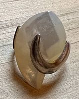 Close-up of ring where the sterling silver wraps around the pearl, highlighting the modern and artistic style