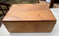 Top view of the vintage rustic pine wood box showing wood grain, scratches, and marks on the surface.