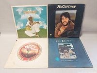 4 vintage vinyl LP albums showing front covers: Taj Mahal, Paul McCartney, Purple Sage Riders, Eric Clapton. Covers have minor wear.
