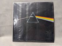 Front cover of The Dark Side of the Moon vinyl record album showing classic prism rainbow design