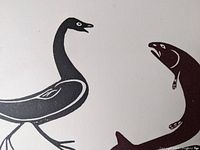 Close-up detail of the stylized goose and Arctic char fish in the black and white print.