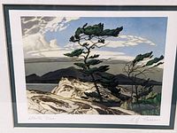 Close-up photo of the framed print showing the pine trees and landscape.