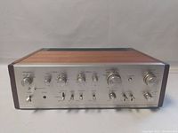 Front view of amplifier with silver faceplate, Pioneer logo, control knobs, input selector, headphone jack and power switch