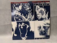 Front cover of The Rolling Stones Emotional Rescue album showing abstract blue and white image with red text title.