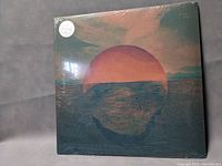 Front cover of Tycho Dive vinyl album showing ocean sunset artwork with sealed shrink wrap and round label.