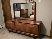 Front angle view of six-drawer dresser with mirror reflection