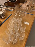 Full view of entire stemware collection showing multiple glasses arranged on wooden table.
