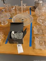 Full lot view showing Waterford crystal vase, cake platter, and multiple crystal serving pieces on wooden table.