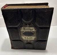 Front cover of the antique German Bible showing embossed dark leather with title 'Heilige Schrift' in gold.