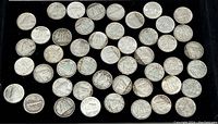Tray of approximately 45 silver dimes arranged in six rows showing obverse and reverse sides.
