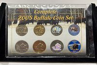 Complete set of eight 2005 buffalo nickel coins in a protective case showcasing different finishes including standard, colorized, hologram, and gold plated versions.