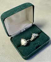 Two Pandora 925 silver rings with cubic zirconia stones displayed in a green velvet ring box.