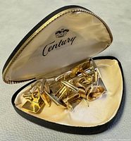 Cufflinks set inside a cream satin lined Century case with black exterior, showing all five pairs.