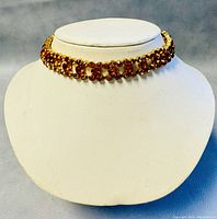 Front view of Art Deco Czechoslovakian faceted amber rhinestone choker displayed on white stand
