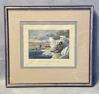 Framed engraving showing Inuit man sitting on ice hunting seals, surrounded by ice and water with other hunters in the distance.